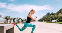Young woman has an outdoor workout on the sea embankment