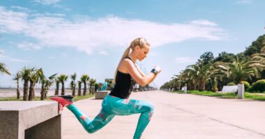 Young woman has an outdoor workout on the sea embankment