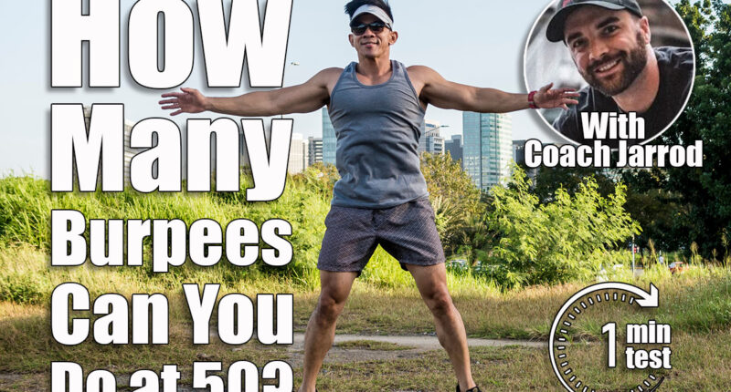 An athletic asian guy does jumping jacks at a open field near the city. Cardiovascular fitness. Working out outdoors. If You Can Do This Many Burpees at 50, You
