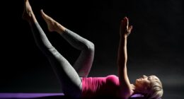 Woman exercising pilates. Dead bug exercise.