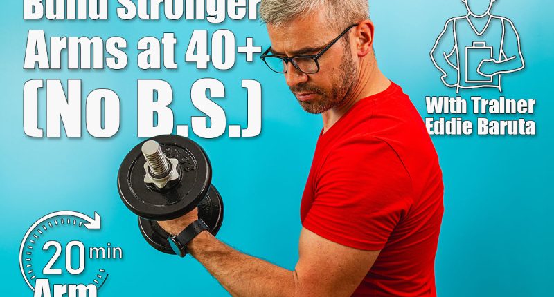 A man with gray hair and glasses exercises by lifting a dumbbell, showcasing strength and determination in a vibrant blue gym environment. Building Stronger Arms After 40 Could Be Way Easier Than You