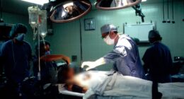 Surgeons performing surgery in an operating room.