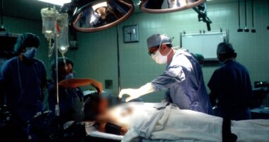 Surgeons performing surgery in an operating room.