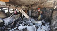 IDF personnel surveying damage at a missile attack site.
