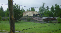 Barbed wire fence in front of an abandoned Soviet-era nuclear missile base.
