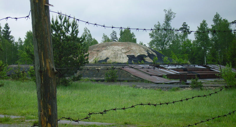 Barbed wire fence in front of an abandoned Soviet-era nuclear missile base.