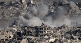 Bomb damage and smoke over rubble-strewn landscape.