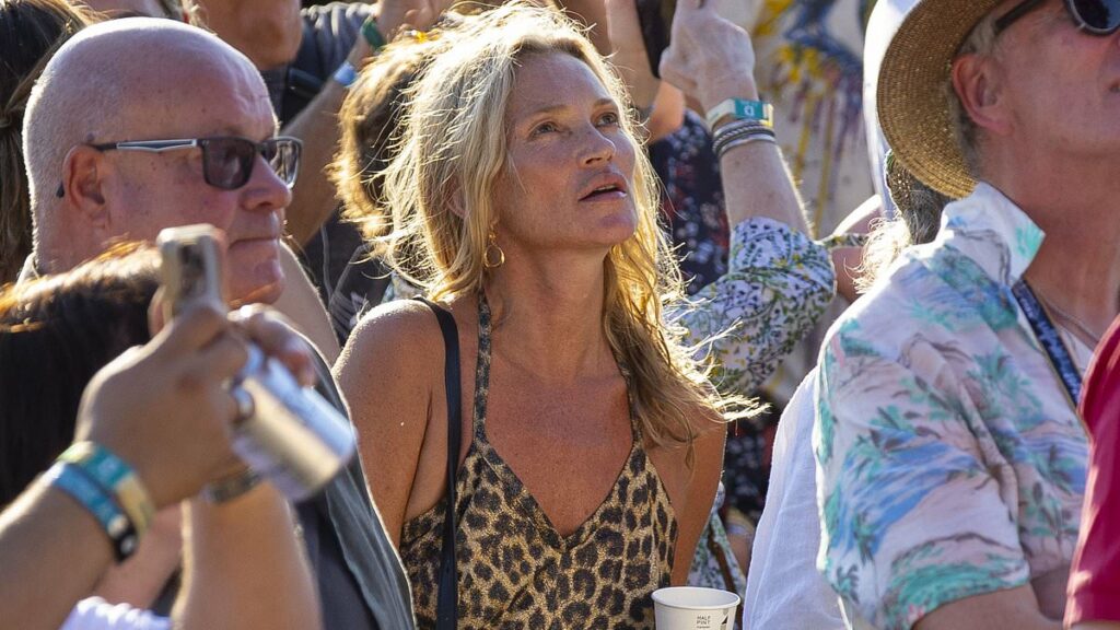 Kate Moss, 51, puffs on a vape and sips a beer at BST Hyde Park