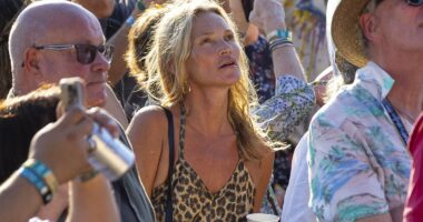 Kate Moss, 51, puffs on a vape and sips a beer at BST Hyde Park