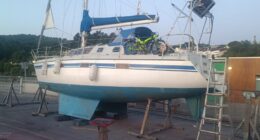 Sailboat on land with a bicycle on deck.