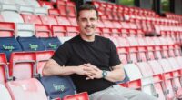 Gary Neville, Sage brand ambassador, sitting in stadium seats.