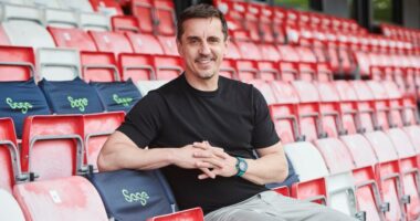 Gary Neville, Sage brand ambassador, sitting in stadium seats.