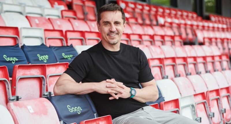 Gary Neville, Sage brand ambassador, sitting in stadium seats.