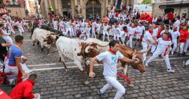 People running from bulls during the San Fermin festival in Pamplona, Spain.