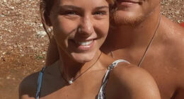 A young woman and man smiling for a selfie.