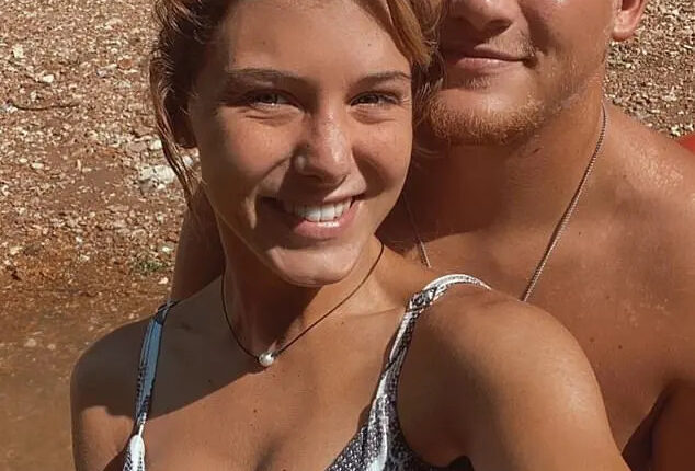 A young woman and man smiling for a selfie.