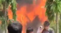 People watching a large fire.