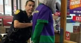 Police officer arresting Chuck E. Cheese mascot at a Florida Chuck E. Cheese restaurant.