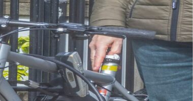 A man placing a USB drive into a bicycle's seat post.