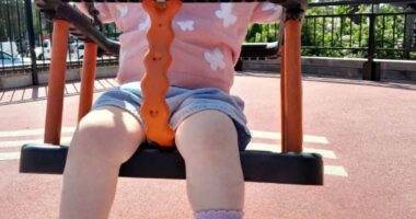 Toddler on a swing.