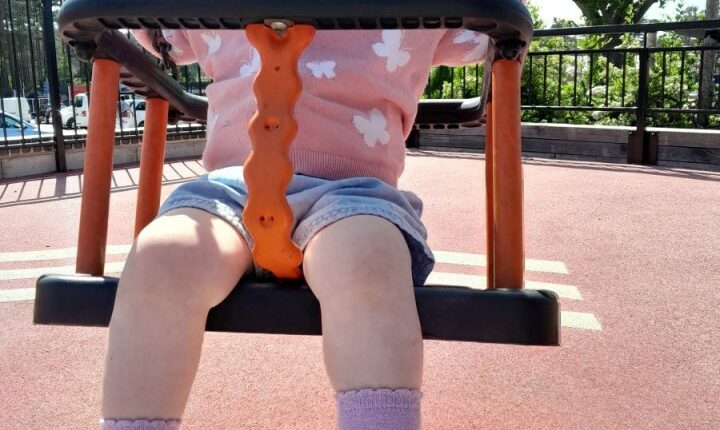 Toddler on a swing.
