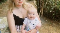 A woman holding a baby on her lap.