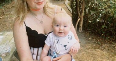 A woman holding a baby on her lap.