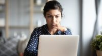 Woman looking concerned at her laptop.