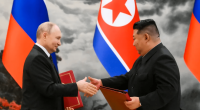 Vladimir Putin and Kim Jong-un shaking hands.