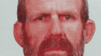 Mugshot of a man with a beard.