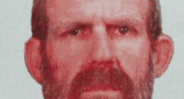 Mugshot of a man with a beard.