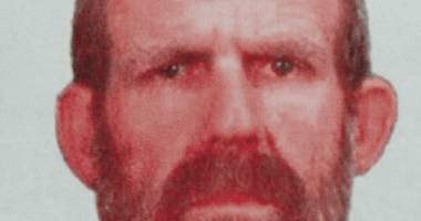 Mugshot of a man with a beard.