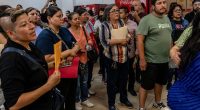Outraged mob of grieving families demand answers over 400 corpses