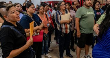 Outraged mob of grieving families demand answers over 400 corpses