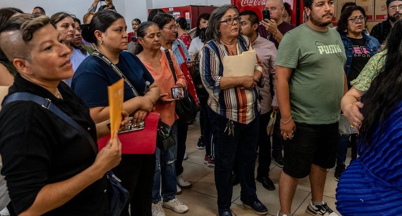 Outraged mob of grieving families demand answers over 400 corpses