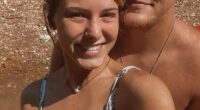 A young woman and man posing for a selfie.  The woman is wearing a snakeskin-print bikini top.