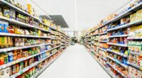 Aisle in a supermarket stocked with various food and drink items.