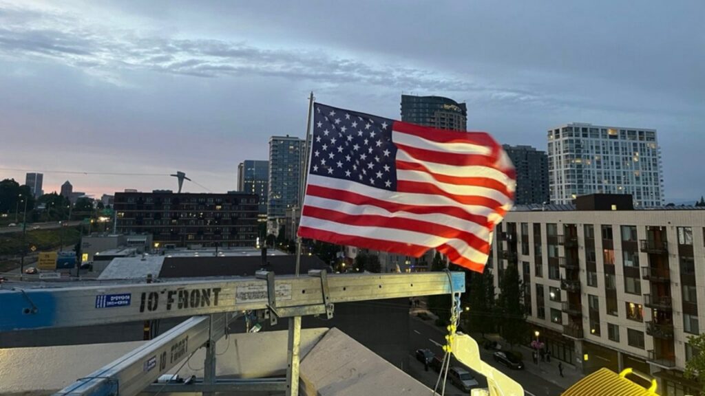 Patriotic ICE officer replaces American flag after protesters burned existing banner at Portland facility
