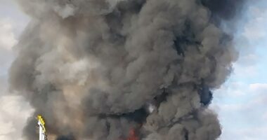 Large fire and smoke billowing from a burning vehicle.