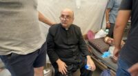 Wounded Palestinians, including Father Jebrail Romanelli, at Al-Ahli Baptist Hospital.