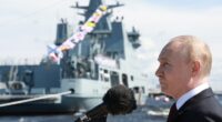 Vladimir Putin speaking at a naval parade.