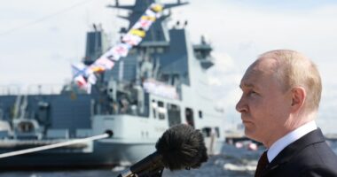 Vladimir Putin speaking at a naval parade.