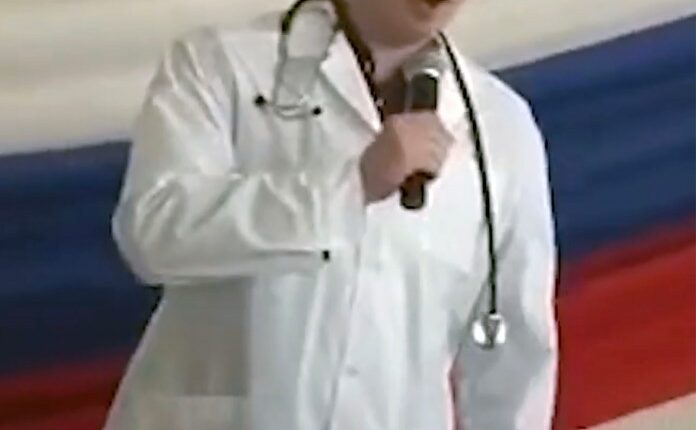 Ilya Sorokin, a Russian prison doctor accused of torturing Ukrainian prisoners of war, speaking into a microphone.
