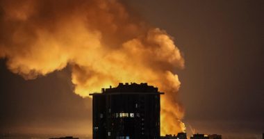 Explosion near a city building at night.