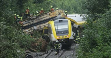 Rescue workers attending to a derailed train.