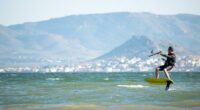 Kite surfer hydrofoiling on the ocean.
