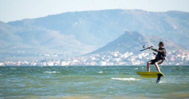 Kite surfer hydrofoiling on the ocean.