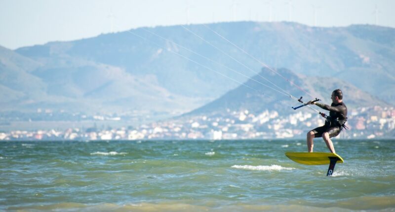 Kite surfer hydrofoiling on the ocean.