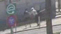 Low-quality security camera footage of a mugging.