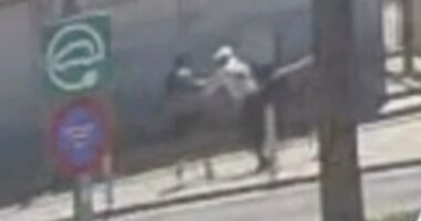 Low-quality security camera footage of a mugging.